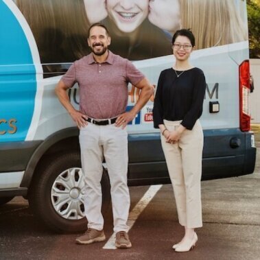 Orthodontist Standing in Front of Van 